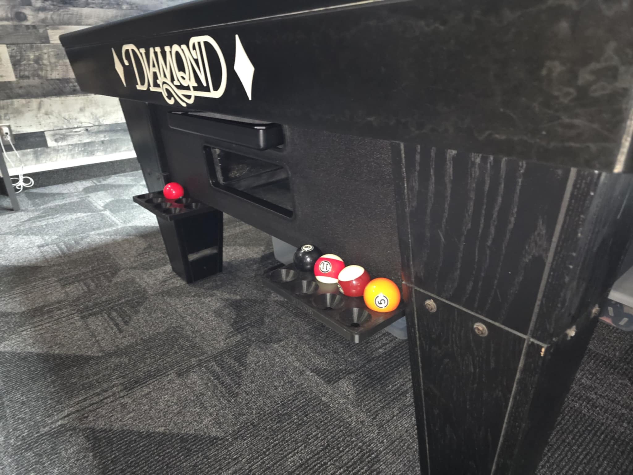 Ball Pod mounted on a pool table during a 9‑ball game.